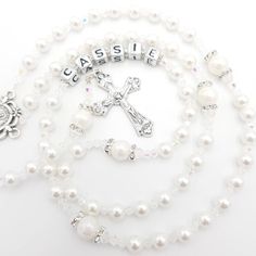 Elegant and personalised Rosary beads made with white pearl beads. Beautiful gift for many occasions such as a christening, first holy communion, baptism, confirmation and much more! Add a name and/or Saint pendant to personalise and choose your own centrepiece with a wide variety available. Please select the colour of the Hail Mary beads from drop down menu then choose the centrepiece you would like as numbered in photos. Made with -6mm white pearl beads (Hail Mary) -8mm white pearl beads (Our Pearl White Rosary For First Communion, Handmade White Jewelry For Confirmation, White Pearl Rosary As A Gift, White Pearl Rosary As Gift, Personalized White Jewelry For Baptism, Elegant White Rosary For First Communion, White Rosary With Round Beads For Confirmation, White Pearl Rosary For Baptism, White Spiritual Rosary For Baptism