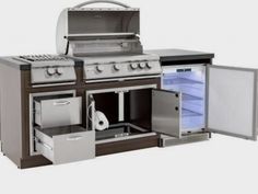 an outdoor kitchen with stainless steel appliances and refrigerator