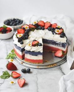 an american flag cake with strawberries and blueberries on the top is ready to be eaten