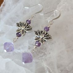 These Beautiful Amethyst Gemstone Earrings Feature A Stunning Silver Lotus Charm As The Center Of Attention. Hanging Delicately From The Bottom Of The Lotus; Ametrine Gemstones Dangle Gracefully And Sparkle In The Light. Silverite Amethyst Gemstone Rhondelles Cap The Silver Lotus. This Eye Catching Combination Of Stones Makes A Stunning Addition To Any Jewelry Collection Or Special Occasion Outfit. Handmade Silver Amethyst Drop Crystal Earrings, Silver Amethyst Drop Earrings, Lavender Amethyst Earrings With Natural Stones, Silver Spiritual Crystal Earrings Nickel Free, Silver Amethyst Dangle Crystal Earrings, Silver Amethyst Crystal Earrings With Ear Wire, Silver Nickel-free Spiritual Crystal Earrings, Nickel-free Silver Amethyst Crystal Earrings, Nickel-free Amethyst Earrings For Healing