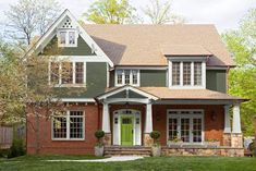 a green house with white trim and windows