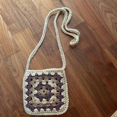 a crocheted purse sitting on top of a wooden floor