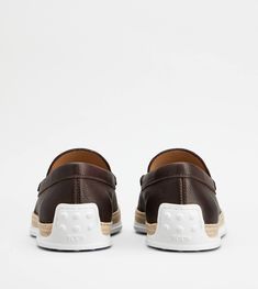 Loafers in slipper version, crafted in soft full grain leather with exposed grain, with stamped Tod's monogram and exposed stitching. Rubber outsole with embossed rubber pebbles and raffia weaving with artisanal detailing. Raffia Weaving, Slipper Loafers, Brown Slippers, Full Grain Leather, Leather Upper, Dust Bag, Grain, Slippers, Loafers