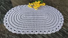 a crocheted placemat with yellow flowers on it