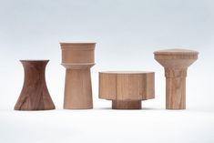 three wooden stools and two small tables on a white background