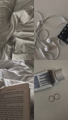 an open book sitting on top of a bed next to headphones and earbuds