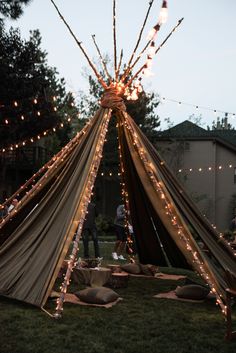 a teepee with lights hanging from it's sides