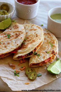 three quesadillas are stacked on top of each other with salsa in the background