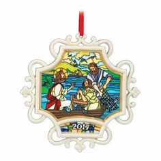 a christmas ornament with an image of jesus and mary in a boat on the water