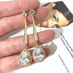 "A pair of linear drop dangle cz drop 1920s vintage style Art Deco bridal earrings with pave bar posts and clear cubic zirconia teardrop dangles. These dainty but stunning and lightweight jewelry in a choice of 3 tarnish-resistant plating; silver rhodium, yellow gold or rose gold. Earrings are about 2\" (5cm) including posts. View all earrings at http://etsy.me/1f8VFT4" Classic Gold Drop Chandelier Earrings, Classic Cubic Zirconia Chandelier Earrings For Wedding, Glamorous Drop Chandelier Earrings For Anniversary, Classic Drop Chandelier Earrings With Elegant Design, Gold Long Drop Bridal Earrings, Gold Long Drop Bridal Earrings For Formal Occasion, Classic Drop Chandelier Earrings For Wedding, Glamorous Drop Bridal Earrings For Formal Occasions, Classic Long Drop Chandelier Earrings For Formal Occasions