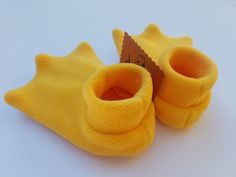 a pair of yellow slippers sitting on top of a white table