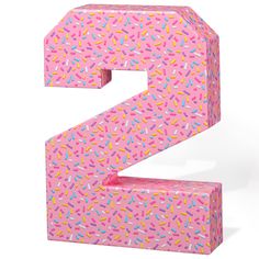 the letter e is made up of sprinkles and pink paper with multicolored sprinkles