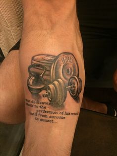 a man with a tattoo on his leg that says stop and dumbble weights