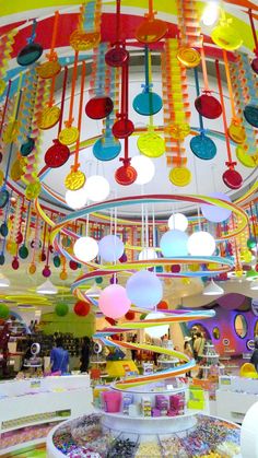 the colorful chandelier is hanging from the ceiling in the store's interior