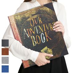 a woman holding a book with the words our adventure book on it