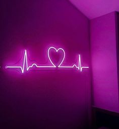 a neon sign that says i love you in the shape of a heart on a purple wall