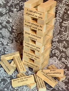 wooden blocks stacked on top of each other with some words written on the sides of them