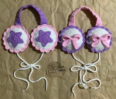 three crocheted purses with bows on them