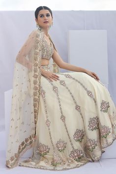 Beige and cream can can attached lehenga with cutdana embellished lotus patterns. Comes with padded embellished blouse and dupatta.
Components: 3
Pattern: Embroidered
Type Of Work: Cutdana,Mirrorwork
Neckline: V-neck
Sleeve Type: Sleeveless
Fabric: Organza,Net
Color: Beige,Cream
Other Details: 
Attached lining
Length:
Blouse: 13 inches
Lehenga: 44 inches
Dupatta: 2.5 mtr
Closure: 
Blouse: Back hook
Lehenga: Side hook
Occasion: Wedding,Bride - Aza Fashions Designer Cream Lehenga For Festivals, Cream Lehenga With Dupatta For Reception, Designer Cream Lehenga For Diwali, Cream Designer Lehenga For Diwali, Traditional Cream Lehenga With Mirror Work, Cream Bollywood Lehenga With Traditional Drape, Cream Lehenga With Sheer Dupatta Floor-length, Designer Beige Lehenga For Diwali, Designer Wear Beige Lehenga For Diwali