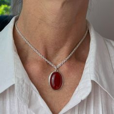 This carnelian pendant is bezel set on a cable chain. And the smooth, polished gemstone in burnished red makes a nice statement wherever you are. It makes a great gift for a friend or family member who likes gemstone pendants in warm colors. Made from nickel-free sterling silver and genuine carnelian. Size:- The pendant length is 1"- The pendant width is 11/16"- The gemstone is 25 x 18 millimeters- The chain length 14”- The chain width is 2.8 millimeters Handmade:This pendant is handmade with a Carnelian Necklace, Gemstone Pendant Necklace, Carnelian Pendant, Gemstone Pendants, Gemstone Necklace Pendant, 21 Days, Rope Chain, Bezel Setting, Cable Chain