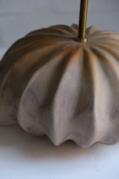 a ceramic pumpkin sitting on top of a white table