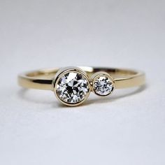 two diamond rings sitting on top of each other