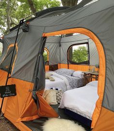 an orange and gray tent with two beds in it