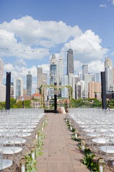 an outdoor ceremony set up in front of the city skyline