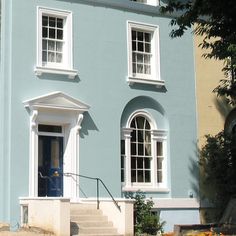 a blue house with white trim and windows