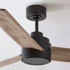 a ceiling fan with a wooden blade attached to it's blades and the light is on