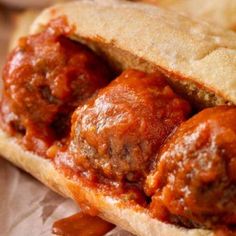 a meatball sub sandwich with tomato sauce on it