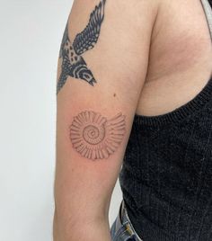 a person with a bird tattoo on their arm