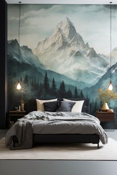 a bedroom with a mountain mural on the wall and two lamps hanging from the ceiling