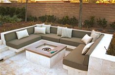 an outdoor seating area with couches and pillows