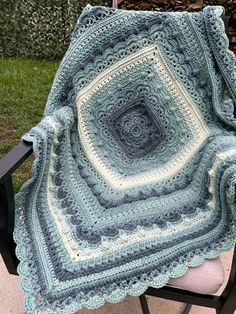 a crocheted blanket sitting on top of a chair