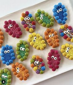 decorated cookies are arranged in the shape of turkeys on a white platter with colorful sprinkles