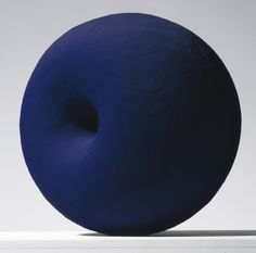 a large blue object sitting on top of a white table next to a gray wall