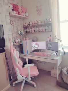 a pink chair sitting in front of a computer desk