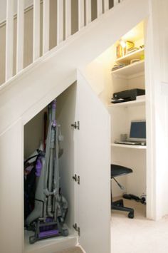 an open closet with a vacuum in it