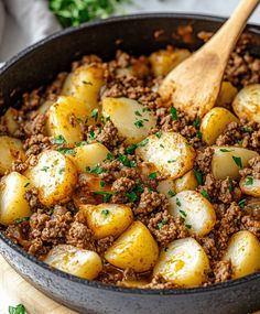 a skillet filled with ground beef and potatoes