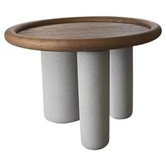 three white and wood stools are stacked on top of each other