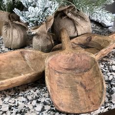 three wooden spoons sitting on top of a granite counter next to burlocks