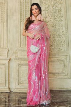 Pink padded blouse with jewel and stone embellished star patterns.
Components: 1
Pattern: Embroidered
Type Of Work: Jewel, stone
Neckline: U-neck
Sleeve Type: Sleeveless
Fabric: Polyester Satin,Net
Color: Pink
Other Details: 
Fitted shilouette
Attached lining
Closure: Back hook
Note: Saree worn by the model is not for sale
Occasion: Party,Cocktail - Aza Fashions Glamorous Organza Blouse Piece, Glamorous Party Saree With Pearl Embroidery, Glamorous Sequin Fabric For Wedding, Hand Embellished Blouse For Wedding, Organza Blouse With Mirror Work For Party, Organza Party Blouse With Mirror Work, Organza Blouse For Celebrations, Glamorous Designer Blouse With Mirror Work, Pearl Embroidery Saree For Reception