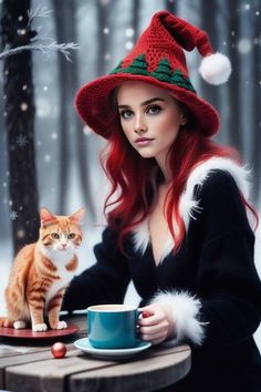 a woman sitting at a table with a cat in front of her and wearing a santa hat