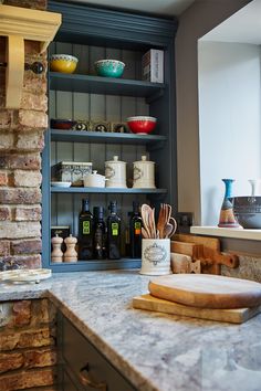 the kitchen counter is full of cooking utensils