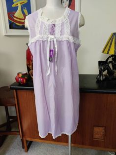 This is a new old stock night gown with tags in a pretty mauve colour with contrasting white lace trim by St Mark label probably 70s. Of course it is unworn and in very good condition is marked a vintage size 16 to fit 95cm bust 75cm waist 100cm hips according to the label Actual measurements are Bust 108cm Length 92cm Sleeveless Summer Sleepwear With Contrast Lace, Feminine Sleeveless Lace Patchwork Sleepwear, Feminine Sleeveless Sleepwear With Lace Patchwork, Feminine Sleeveless Lace Patchwork Nightgown, Sleeveless Lace Patchwork Nightgown For Sleep, Sleeveless Lace Nightgown For Home, Lace Chemise With Lace Trim For Bedtime, Lace Trim Dress For Sleepover, Purple Lace Sleepwear With Lace Trim