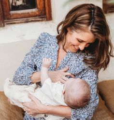 a woman holding a baby in her arms