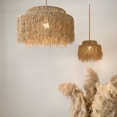 two chandeliers hanging from the ceiling in a room with fluffy fur on them