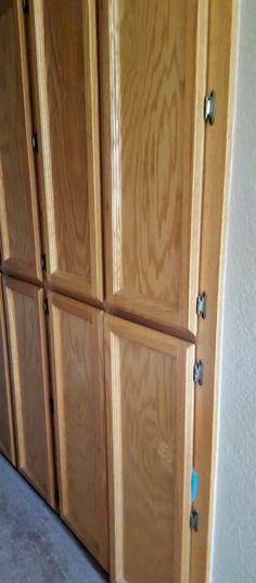 an empty room with wooden doors and carpet