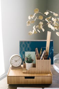 a desk with a clock, pen holder and other items